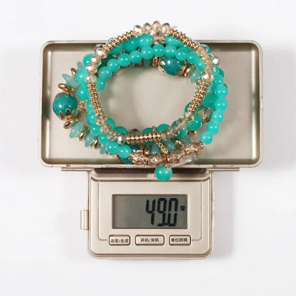 Set de 4 Bracelets Bohèmes Perles Verre Colorées - Pompons et Charms