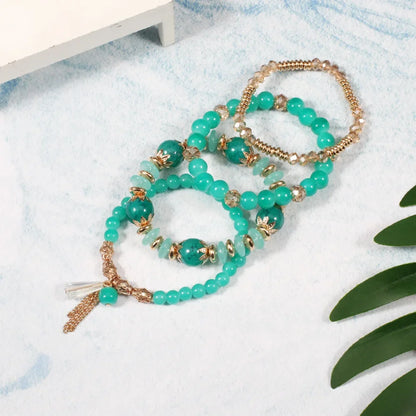 Set de 4 Bracelets Bohèmes Perles Verre Colorées - Pompons et Charms